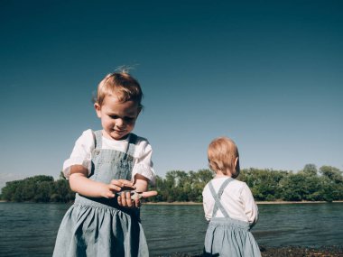 happy sisters on the beach, young girls on vacation