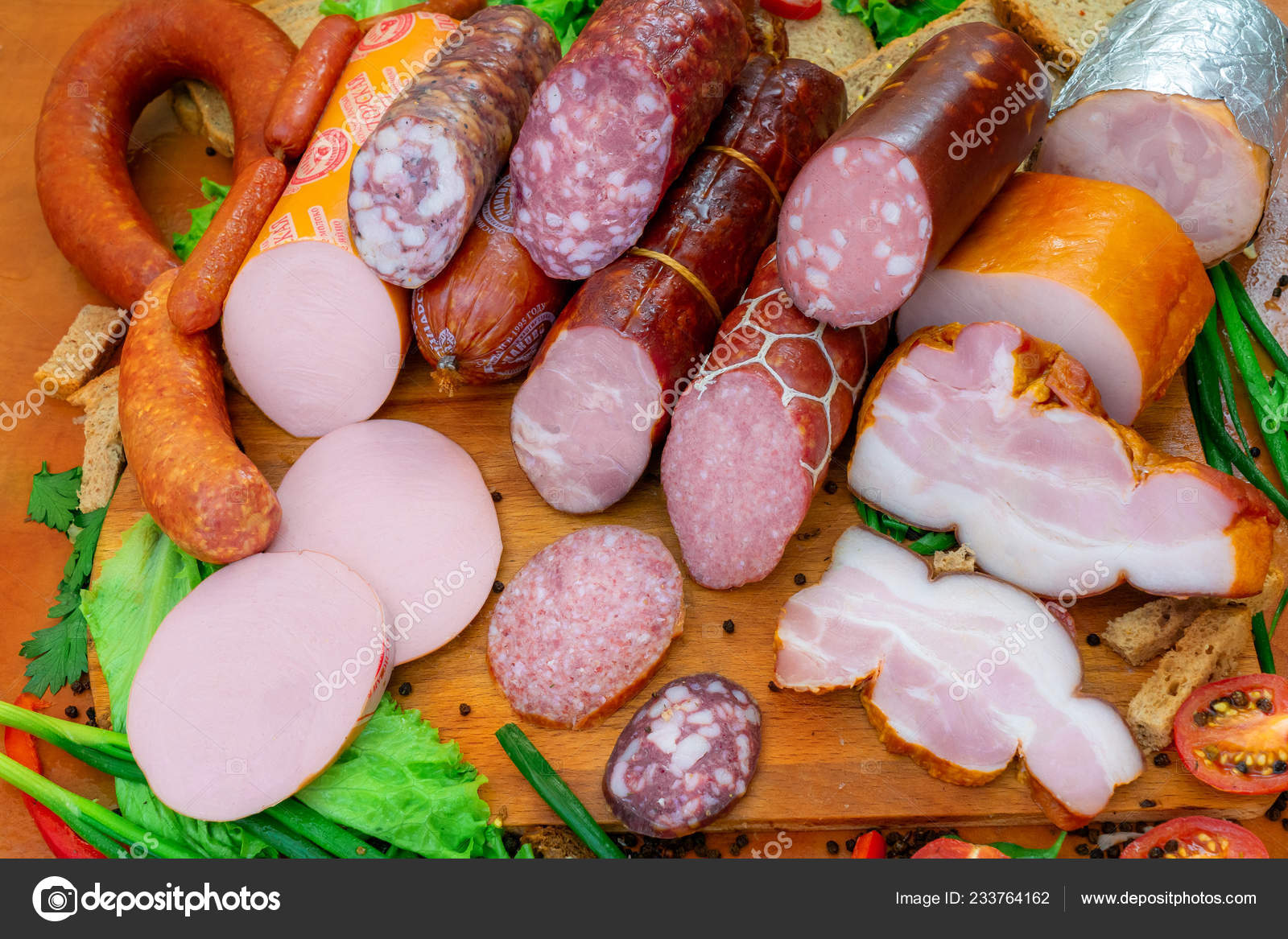Assorted meat products including ham and sausages Stock Photo by