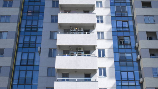 Closeup view of urban building with residential apartments with lit by the sun