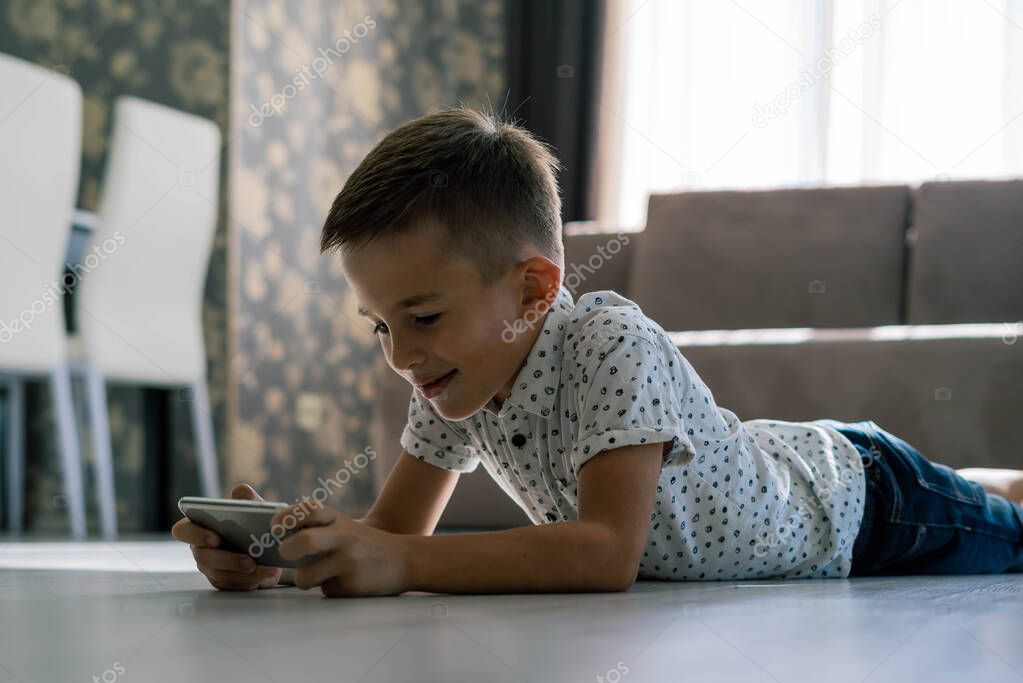 Boy playing game on smartphone