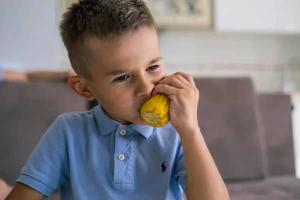 Kid eating cort at home — Stock Photo, Image