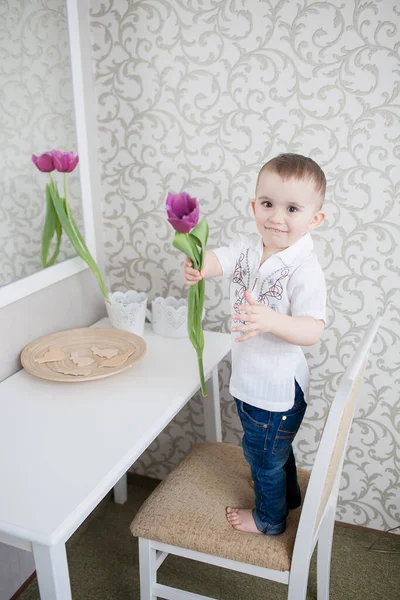 Cute baby boy with tulip — Stock Photo, Image