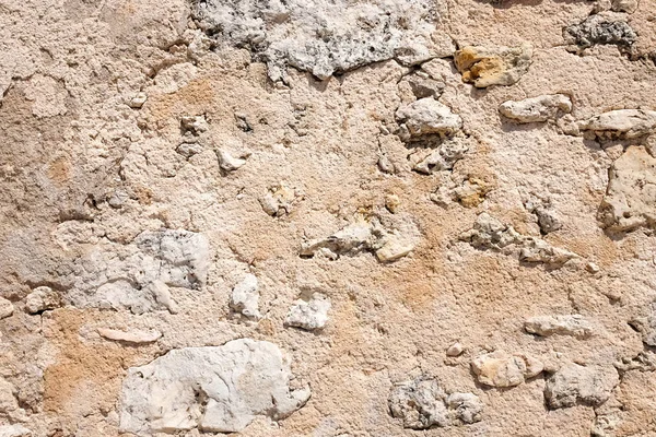 Fragment of the old wall made of volcanic lava and limestone Stock Picture