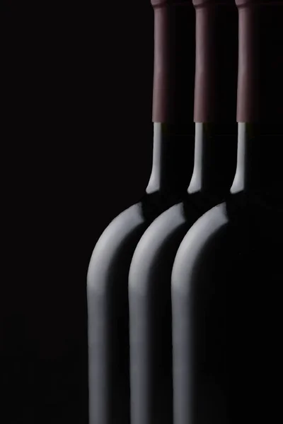 キーの低いワインの瓶のある静物 コピーの領域で 黒の背景に つの赤ワインのボトルのクローズ アップ — ストック写真