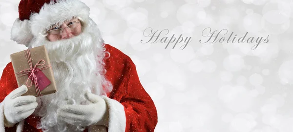 Banner inage dimensioni con Babbo Natale in possesso di un regalo — Foto Stock