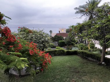 TIBERIAS, ISRAEL - MAY 14, 2018: Grounds of Scots Hotel overlooking the Sea of Galilee. The hotel was once the site of a 19th-century Scottish hospital. clipart