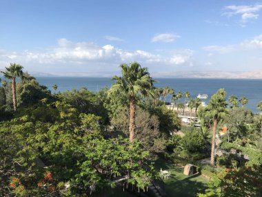 TIBERIAS, ISRAEL - MAY 14, 2018: Scots Hotel grounds overlooking the Sea of Galilee. The hotel was once the site of a 19th-century Scottish hospital. clipart