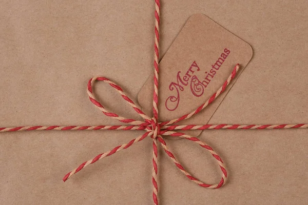 Recyclable plain paper and twine wrapped Christmas Present — Stock Photo, Image