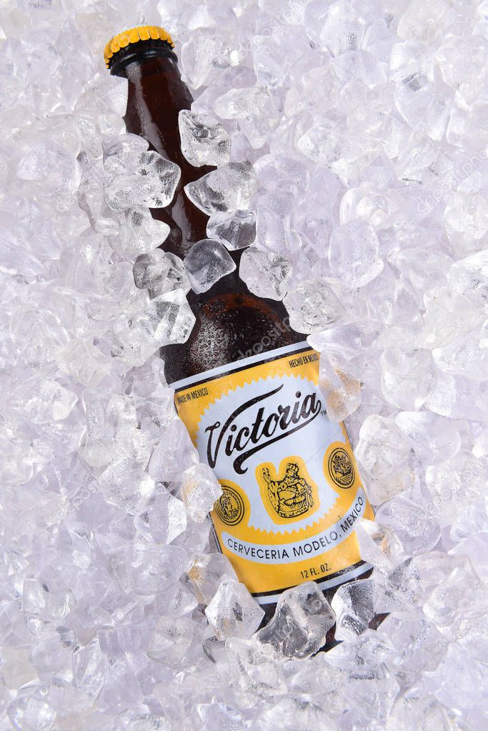 IRVINE, CALIFORNIA - MARCH 29, 2018: Closeup of a  bottle of Victoria Beer in ice. Mexicos oldest beer brand. Victoria has been brewed consistently as a Vienna style lager for 145 years.