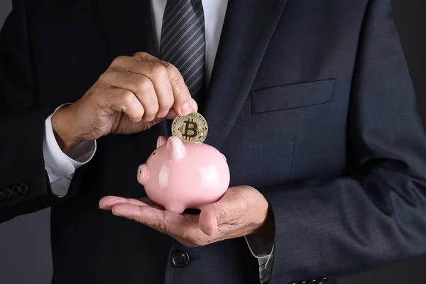 Closeup Businessman Placing Bitcoin Piggy Bank Holding His Other Hand — Stock Photo, Image