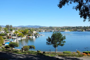 MISSION VIEJO, CA - JANUARY 23, 2018: Lake Mission Viejo, 5 miles south of Santiago Peak in the Santa Ana Mountains, the lake is surrounded by private residential and condominium communities. clipart