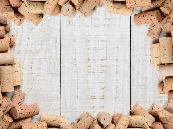 Cork frame: High angle shot on a rustic whitewashed wood table. — Stock Photo, Image