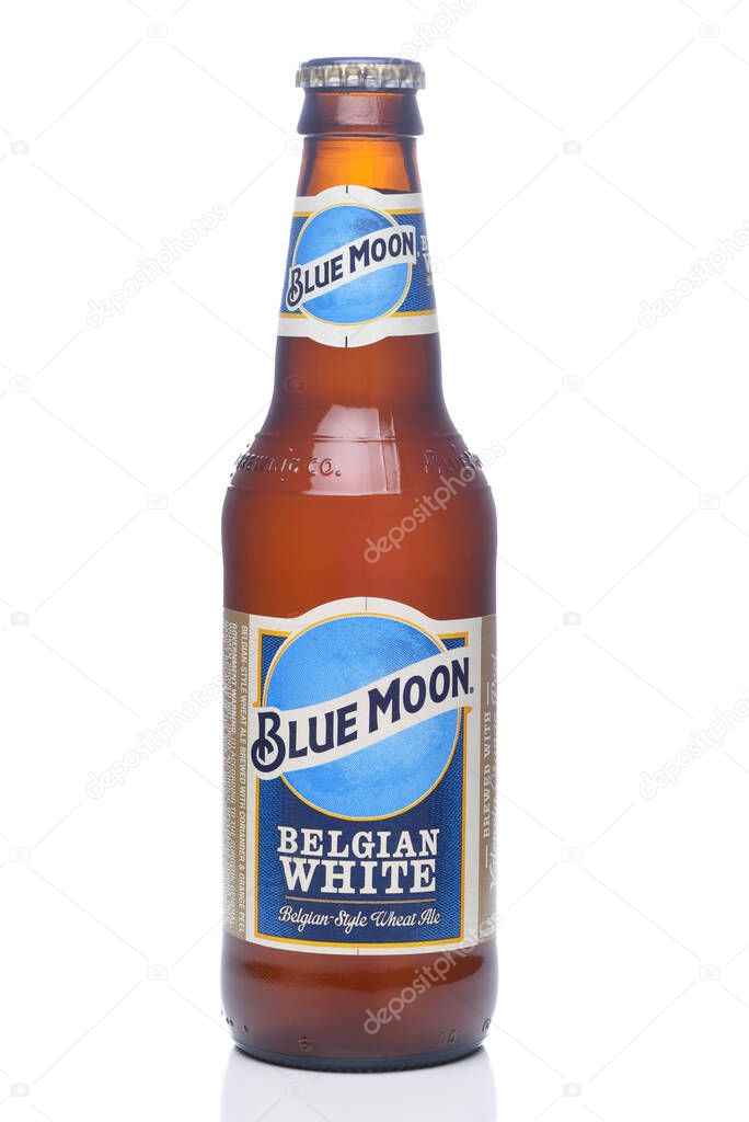 IRVINE, CALIFORNIA - 12 JUNE 2020: A single bottle of Blue Moon Belgian White Wheat Ale with condensation isolated on white with reflection.