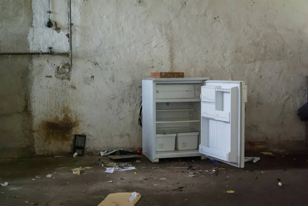 Old broken fridge opeedn in an Abandoned Building