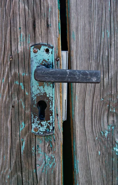 Closeup of old wooden door painted with cracks — Stock Photo, Image