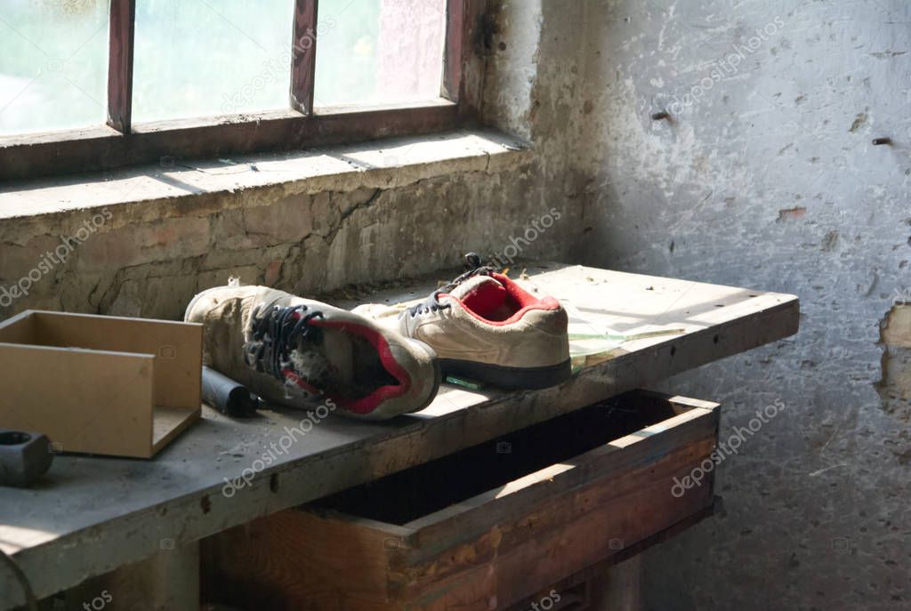 Shoes left behind inside of and abandoned building