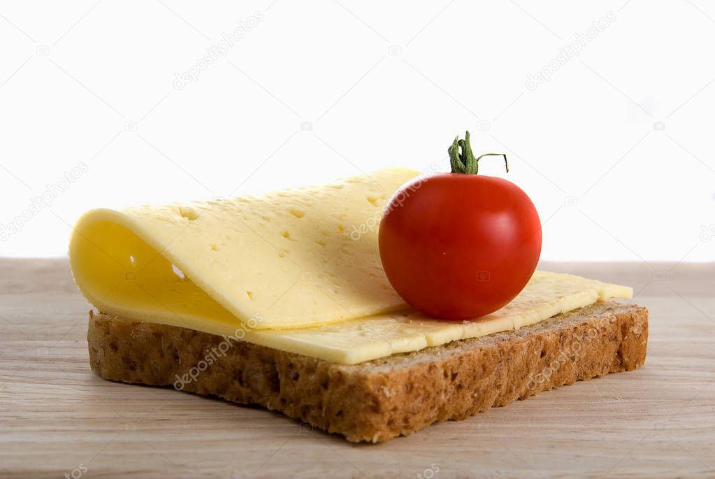 bread slice with cheese cherry tomato on wooden board