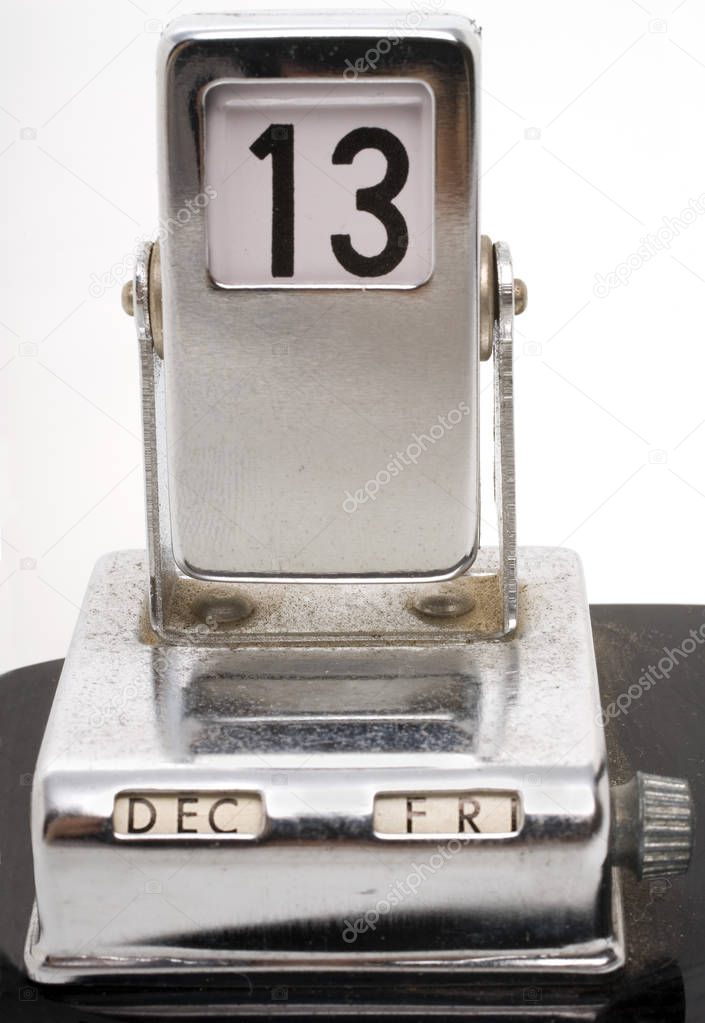 old metallic desk calendar showing Friday 13th