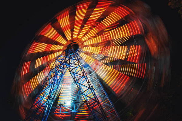 Ferris Wheel at county fair at night, motion blurred