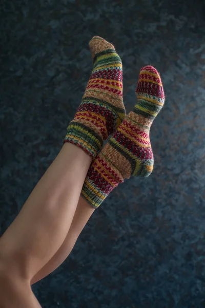 Woman legs in wool knitted socks