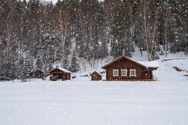 Winter holiday house in forest.