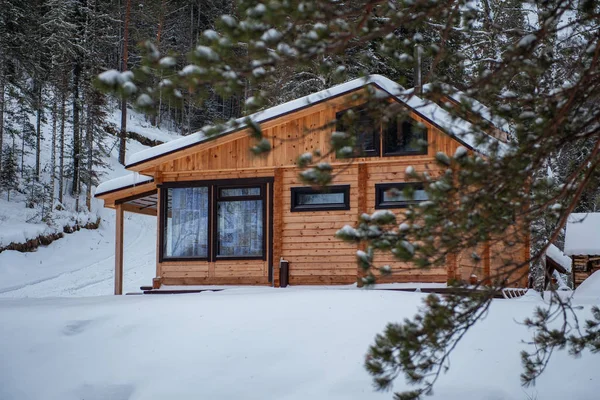 Winter holiday house in forest.