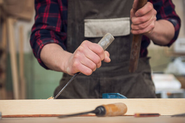 Carpenter working with a chisel