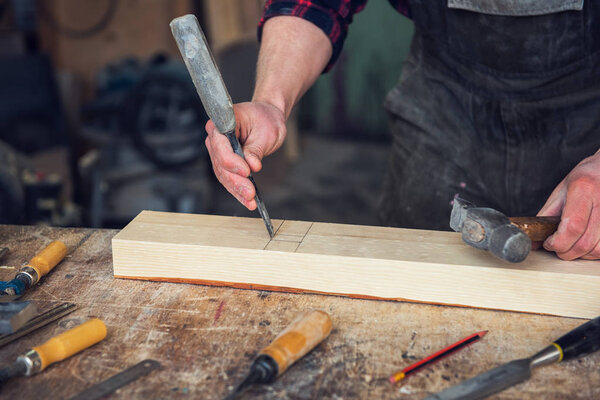 Carpenter working with a chisel