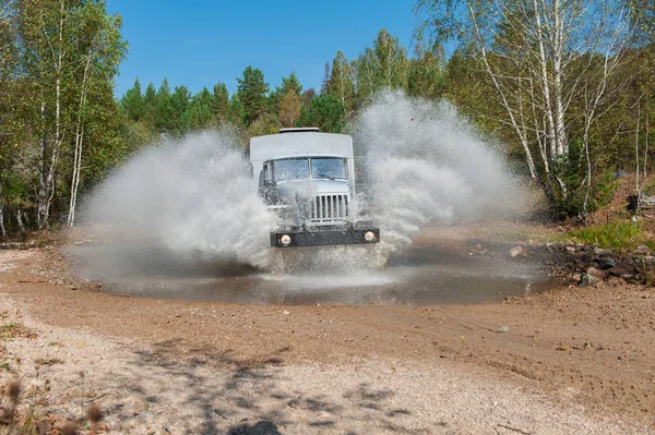 Truck passes through a puddle — Stock Photo, Image