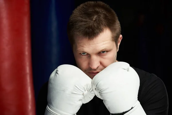 Close-up of boxing man behind gloves