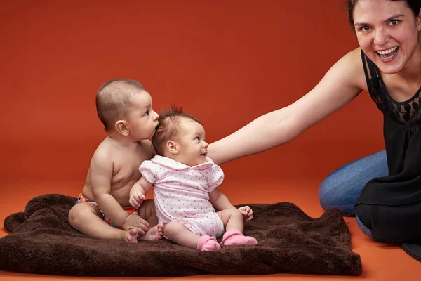 Dos niños pequeños miran a mamá — Foto de Stock