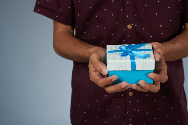 Giving small blue gift box — Stock Photo, Image