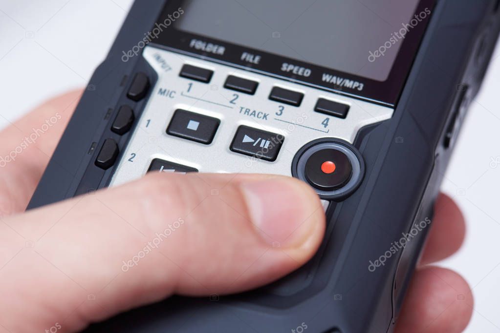 Audiorecorder in hand close up