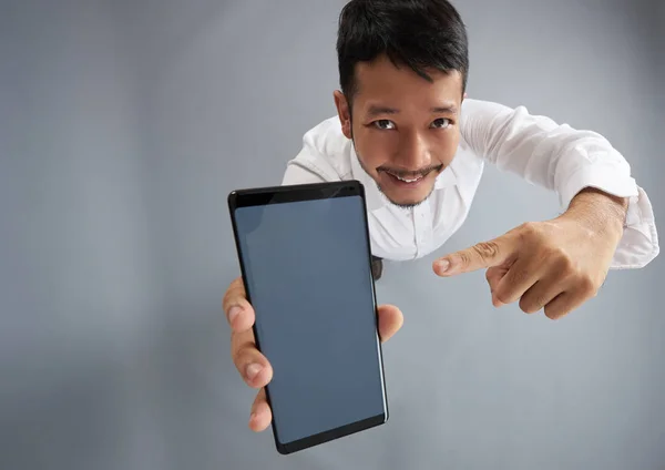 Young man pointing in smartphone screen — Stock Photo, Image