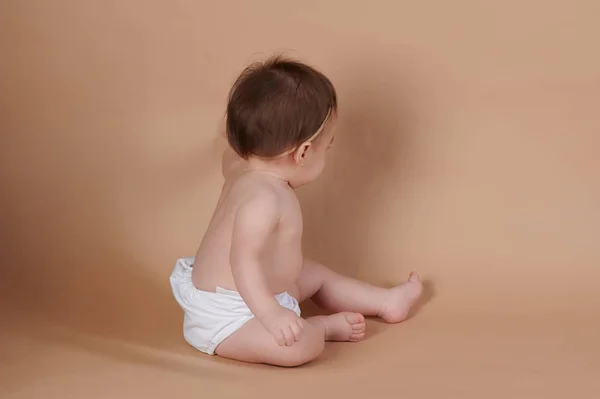 Baby girl touching or drawing on background — Stock fotografie