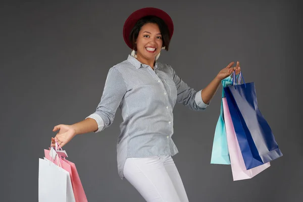 Young smiling woman jump with shop bags