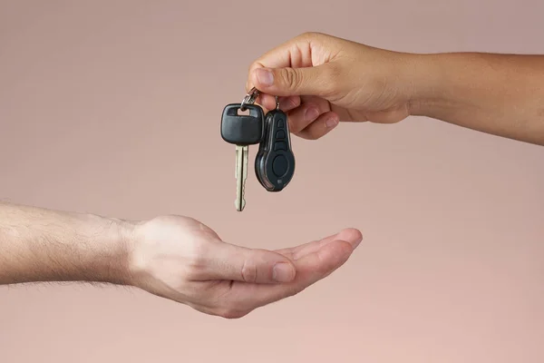 Hand receiving car keys