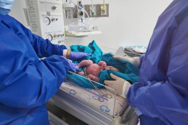 Doktorlar yeni doğan bebeği kontrol