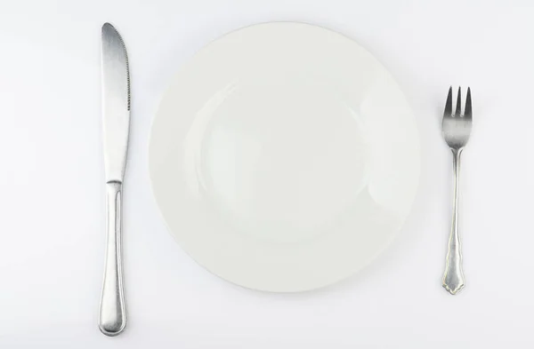White plate with fork and knife — Stock Photo, Image