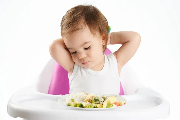 Bored baby girl with food — Stock Photo, Image