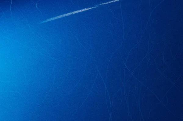 Cat claw scratches on blue paint