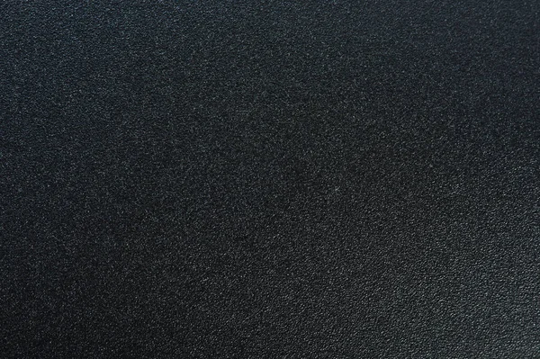 Black matte texture background with grain structure detail
