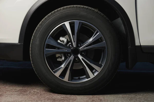 Alloy car wheel rim with break and new tire close up view