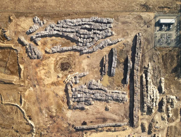 Piles of dry wood on field above top drone view — Stock Image Piles Dry Wood Field Top Drone View Stock Picture