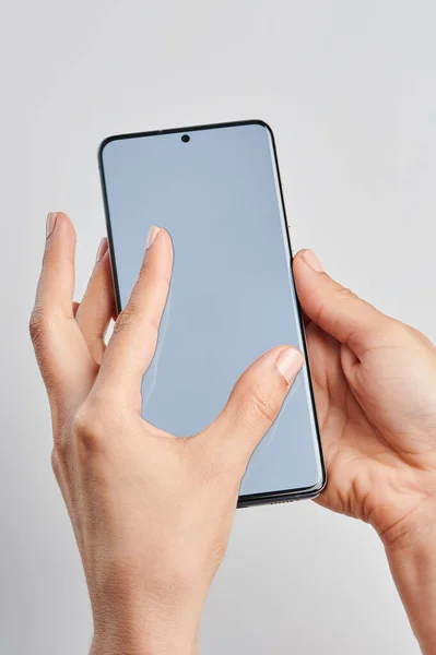 Hands do zoom in on smartphone screen isolated