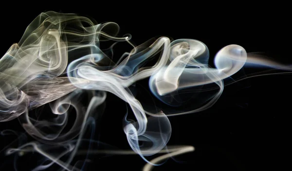 Yellow colorful smoke swirl with smooth shape in black background