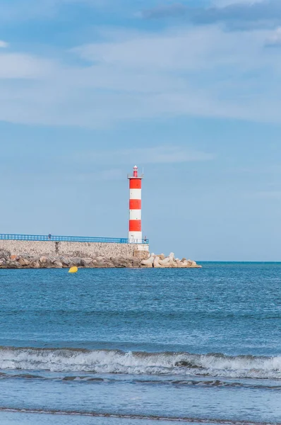 Lighthouse of Port-La-Nouvelle in red and white on cloudy sky — Stock Photo, Image