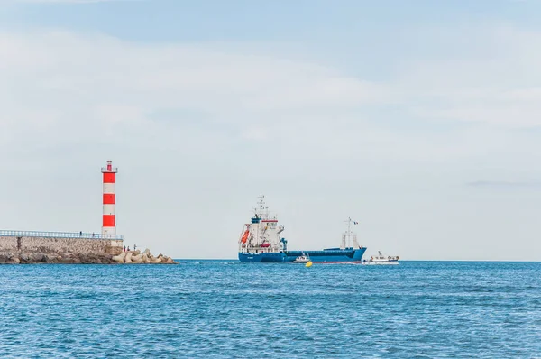 Lighthouse of Port-La-Nouvelle in red and white on cloudy sky — Stock Photo, Image