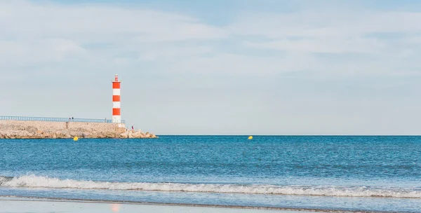 Lighthouse of Port-La-Nouvelle in red and white on cloudy sky — Stock Photo, Image