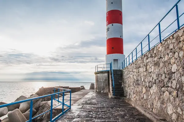 Lighthouse of Port-La-Nouvelle in red and white on cloudy sky — Stock Photo, Image